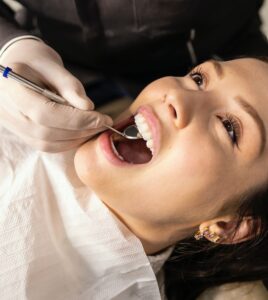 dentist in kettering, checking the health of a patient with strong dental foundations